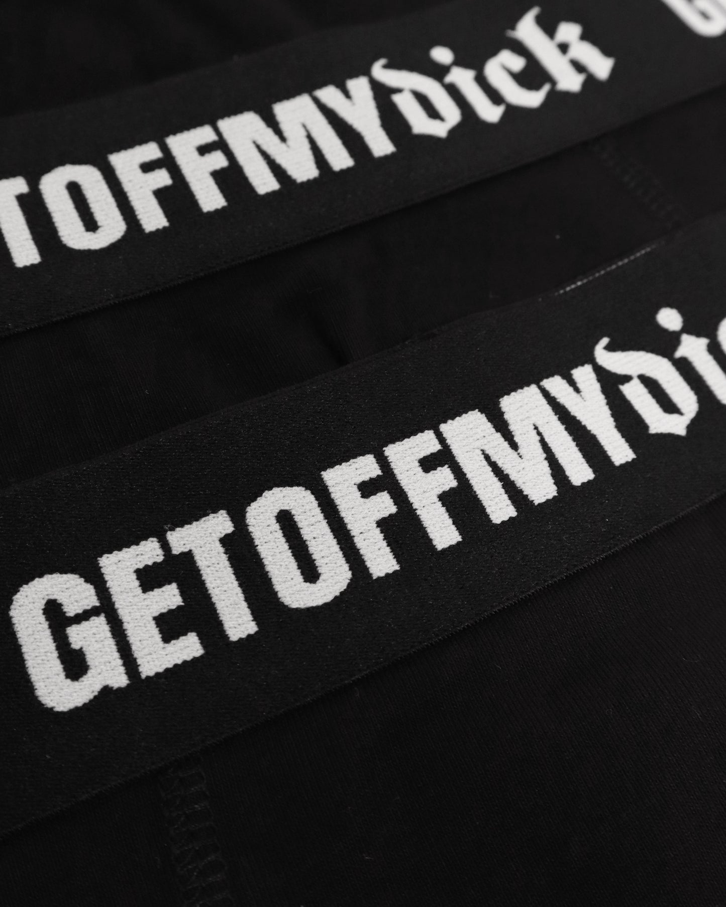 Black headbands with 'GETOFFMYDICK' text on a black background