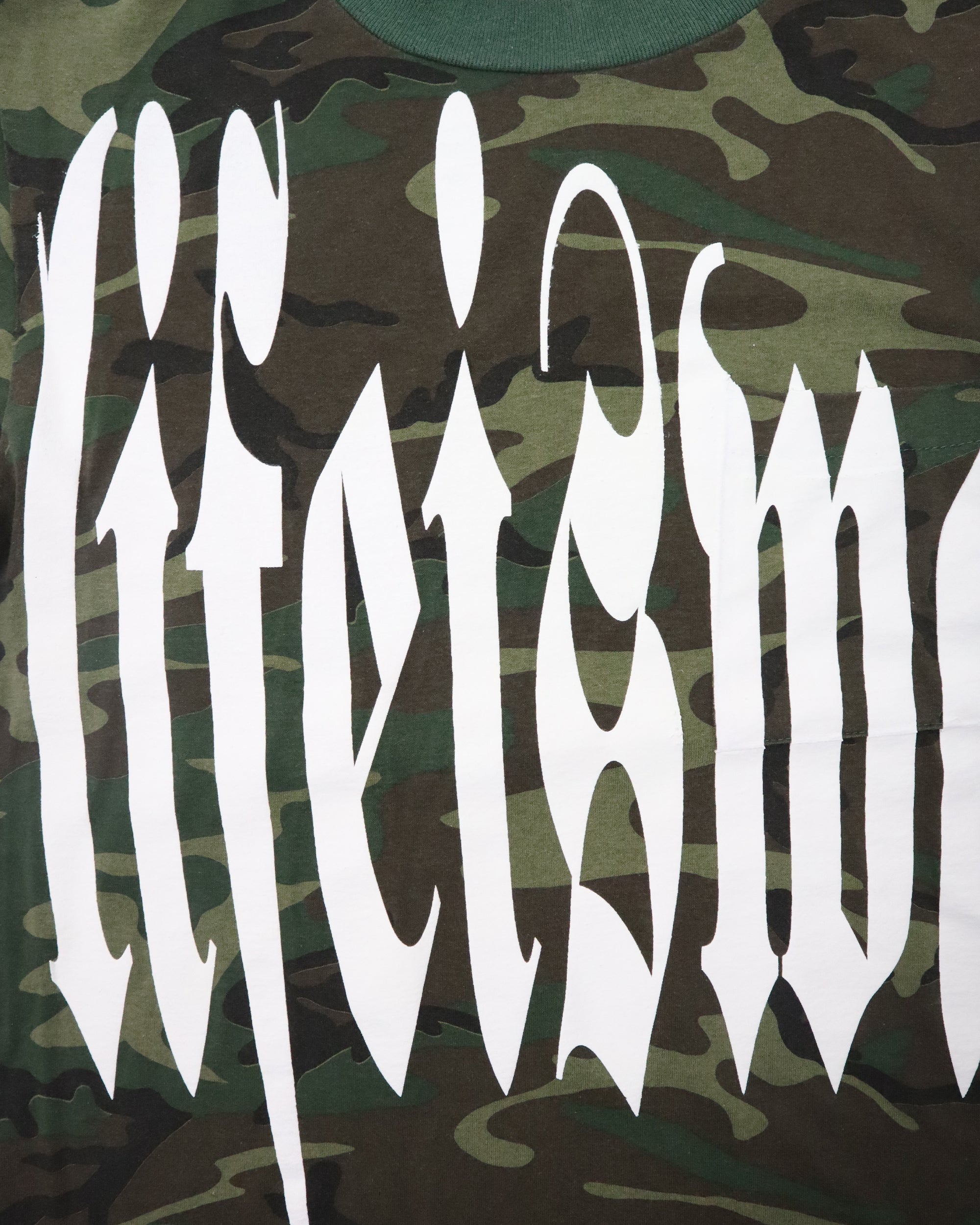 Camouflage pattern with white text on a green background