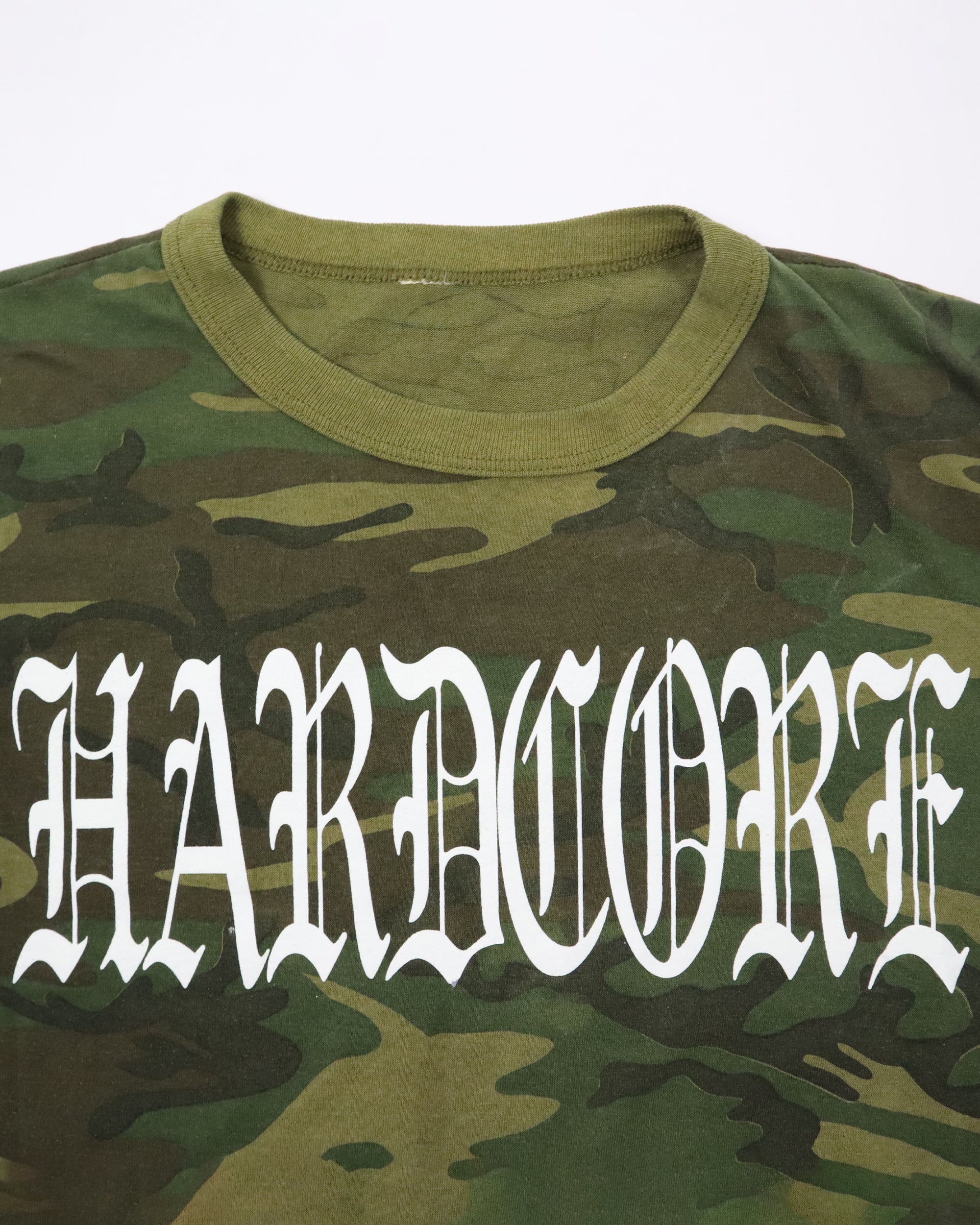 Camouflage t-shirt with 'HARDCORE' text in white on a white background