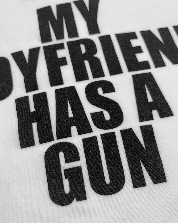 Text on a white background with black letters saying 'MY BOYFRIEND HAS A GUN'.