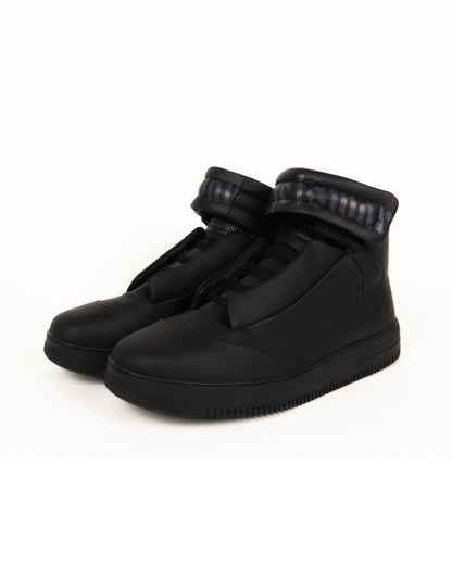 Black high-top sneaker on a white background