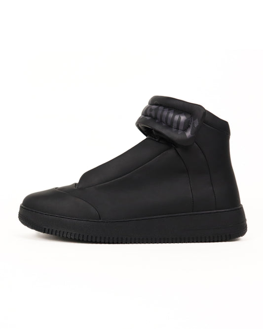 Black high-top sneaker on a white background