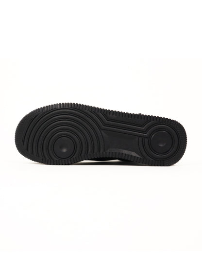 Bottom sole of black high-top sneaker with colorful graphics on a white background