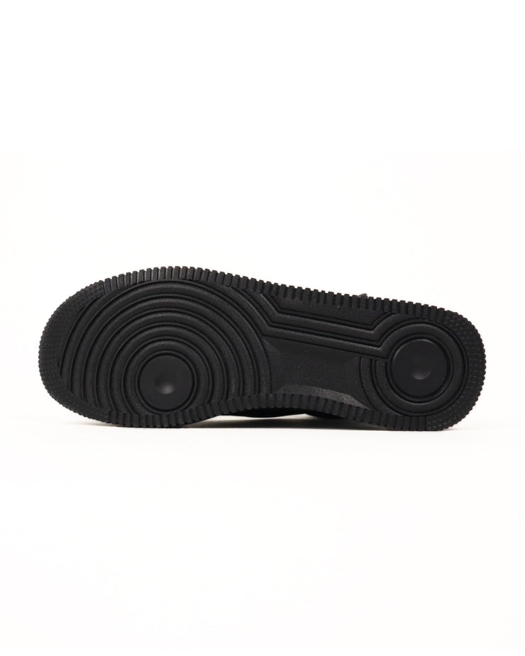 Bottom sole of black high-top sneaker with colorful graphics on a white background