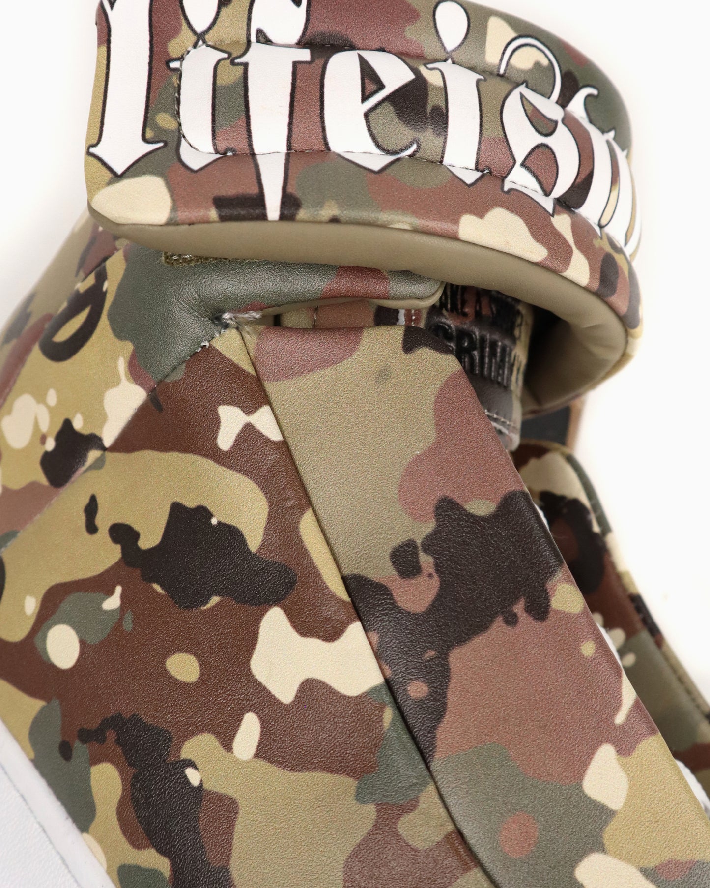 Camo high-top sneaker with camouflage  graphic and “LIFEISWAR” on tongue on a white background