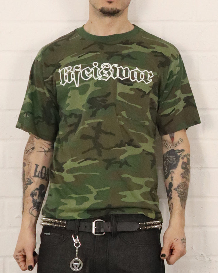 Person wearing a camouflage t-shirt with 'Life is War' text on a white background