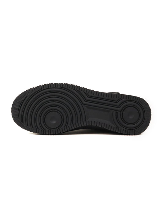 Black sneaker with sole pattern on a white background