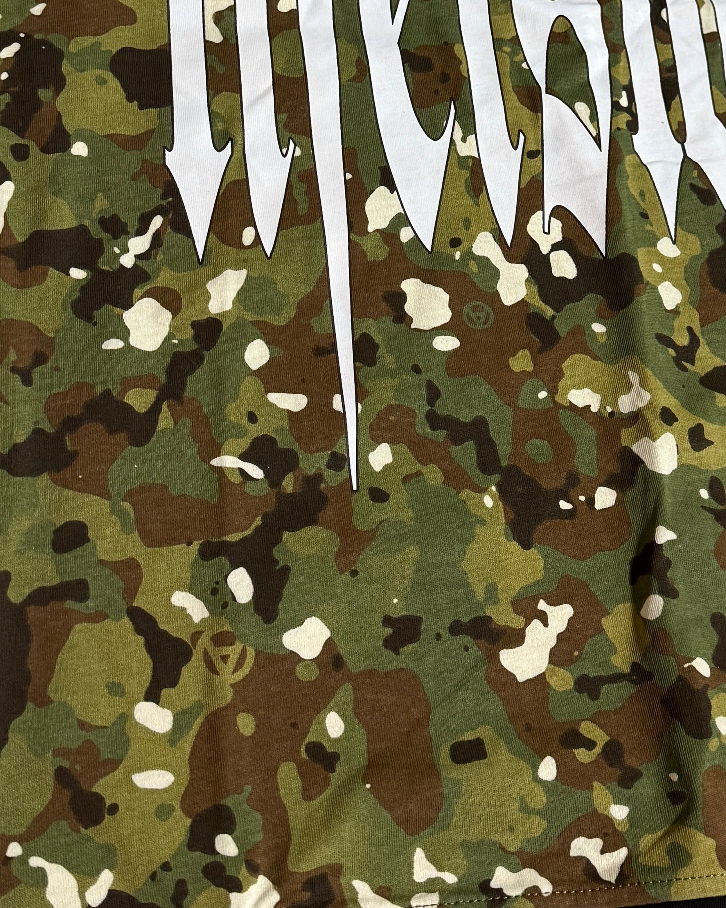 Camouflage fabric with white text 